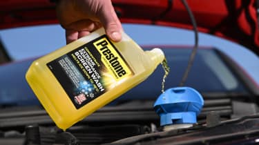 Auto Express products editor Tom Barnard topping a Skoda Superb with Prestone Concentrated Screen Wash